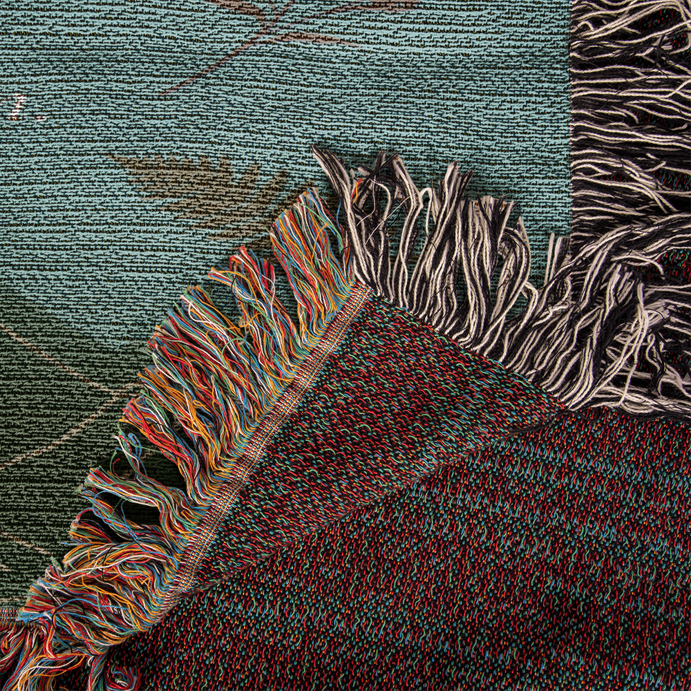 Close-up of woven texture and butterfly artwork on daughter blanke